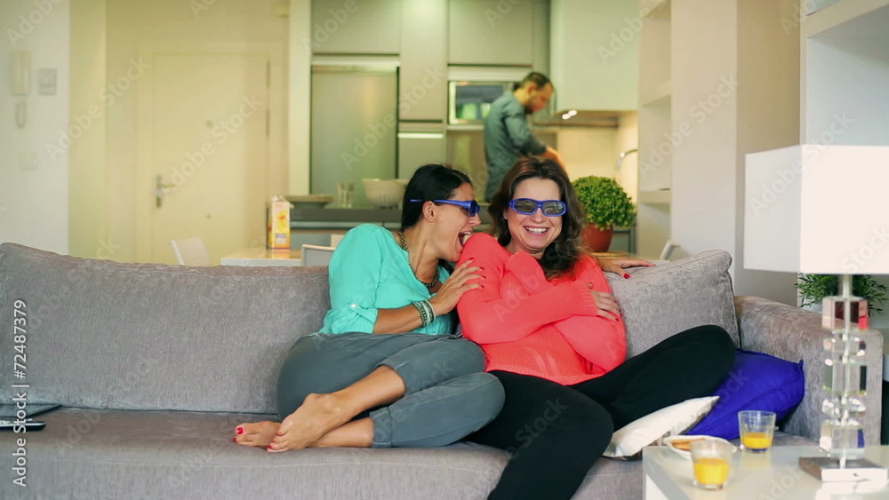 Female friends watching horror in 3d glasses and screaming Female friends watching horror in 3d glasses and screaming