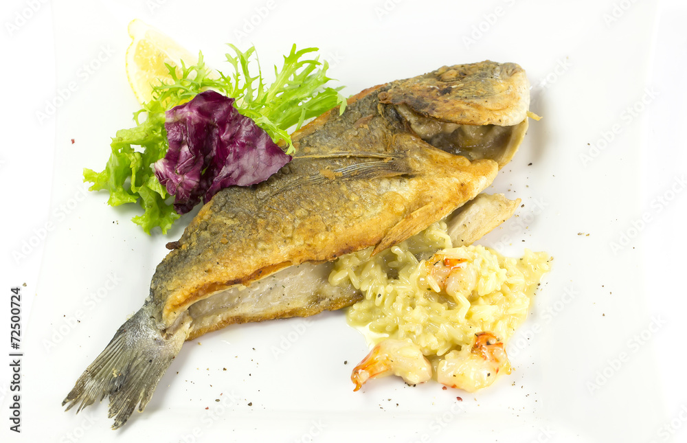 Fried fish dorado with vegetables and lemon Fried fish dorado with vegetables and lemon