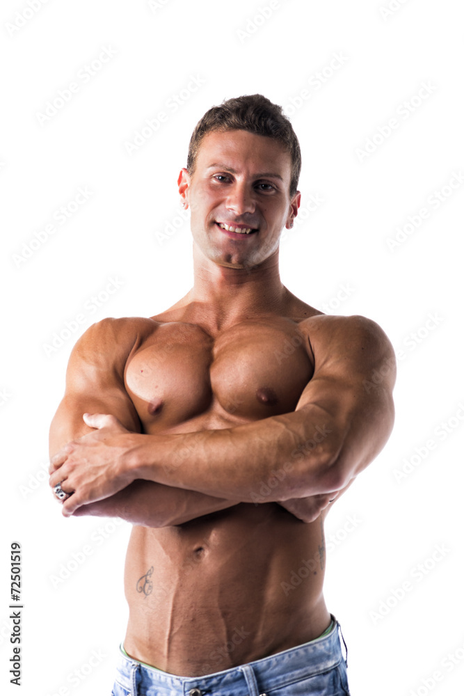 Fototapeta premium Smiling shirtless muscular young man standing with arms crossed