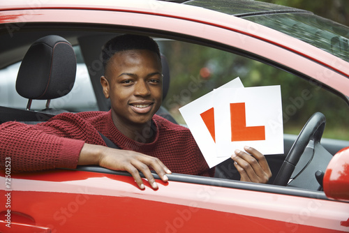 Tableau sur toile Smiling Teenage Boy In Car Passing Driving Exam