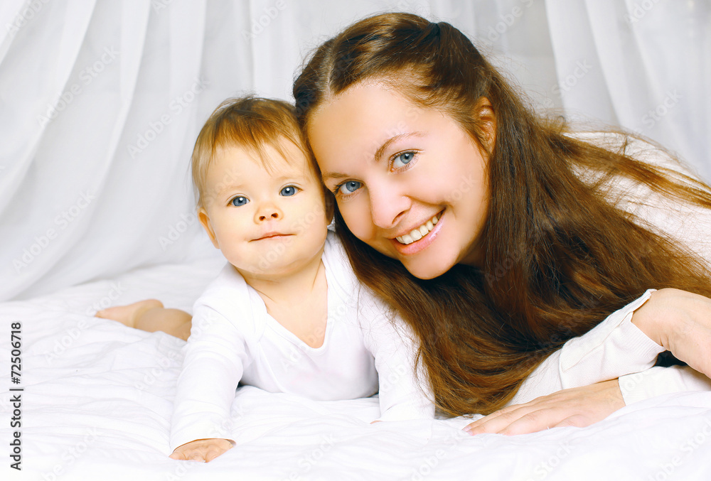 Portrait happy mother and cute baby on the bed home Portrait happy mother and cute baby on the bed home