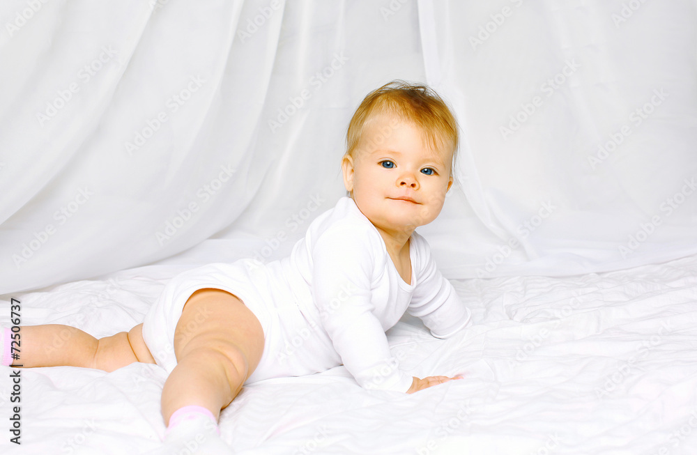 Portrait cute baby lying on the bed home Portrait cute baby lying on the bed home
