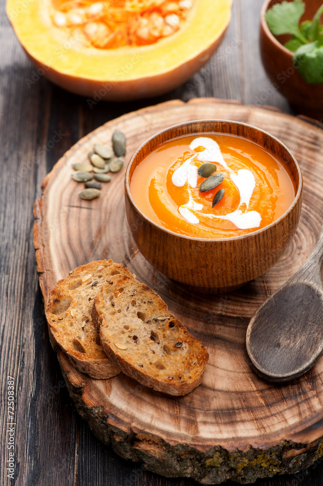 Pumpkin soup on wooden board Pumpkin soup on wooden board