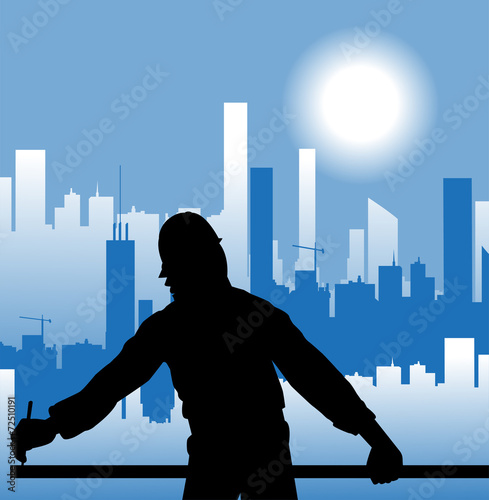 operaio che lavora e città sullo sfondo