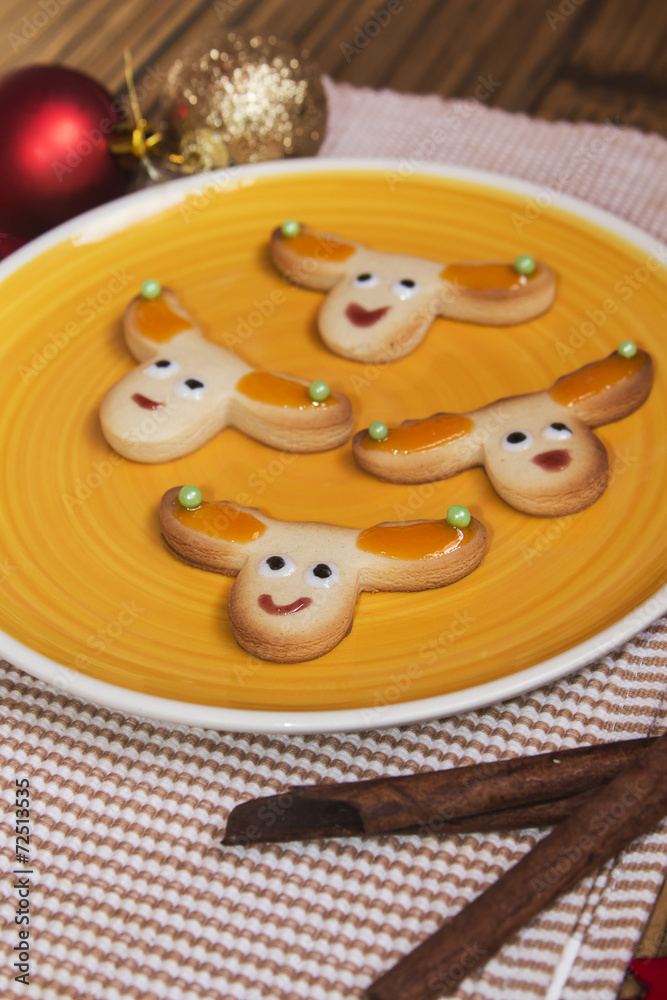 Fototapeta premium Christmas handmade cookies reindeer on wooden background