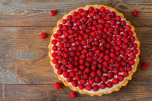 Delicious raspberry tart on a wooden board