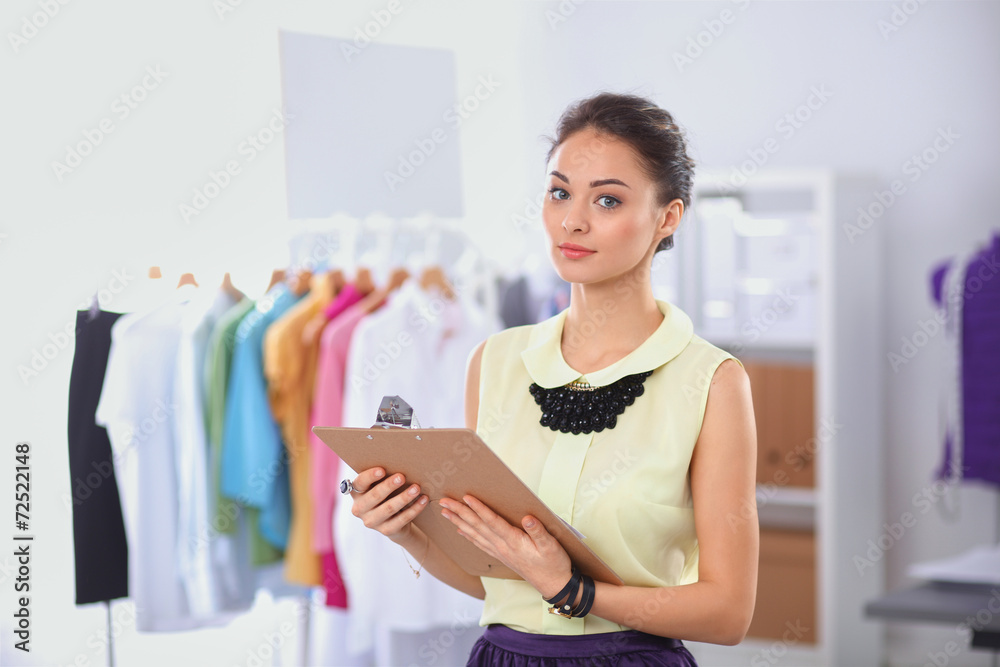 Modern young fashion designer working at studio. Modern young fashion designer working at studio.
