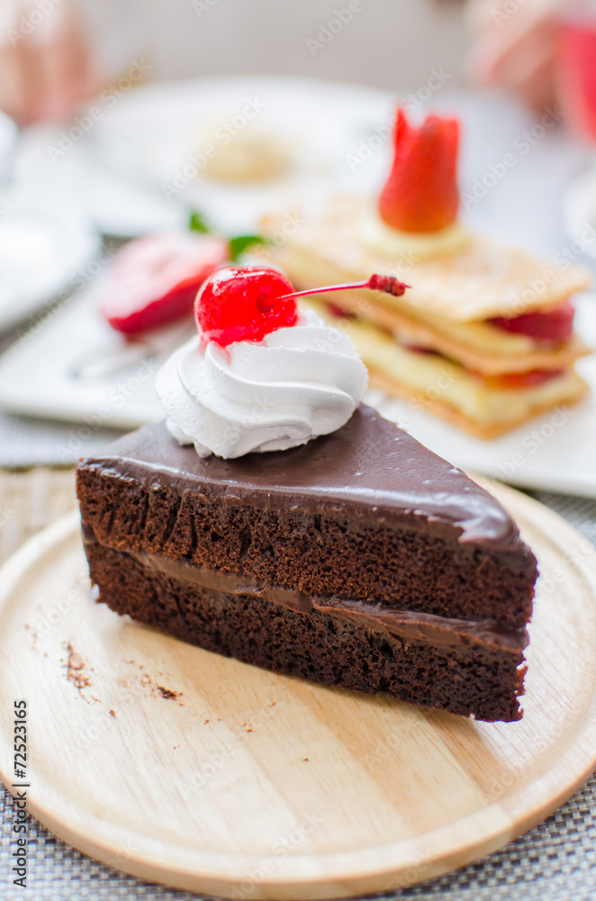 Chocolate cake with cherry and whipped cream Chocolate cake with cherry and whipped cream