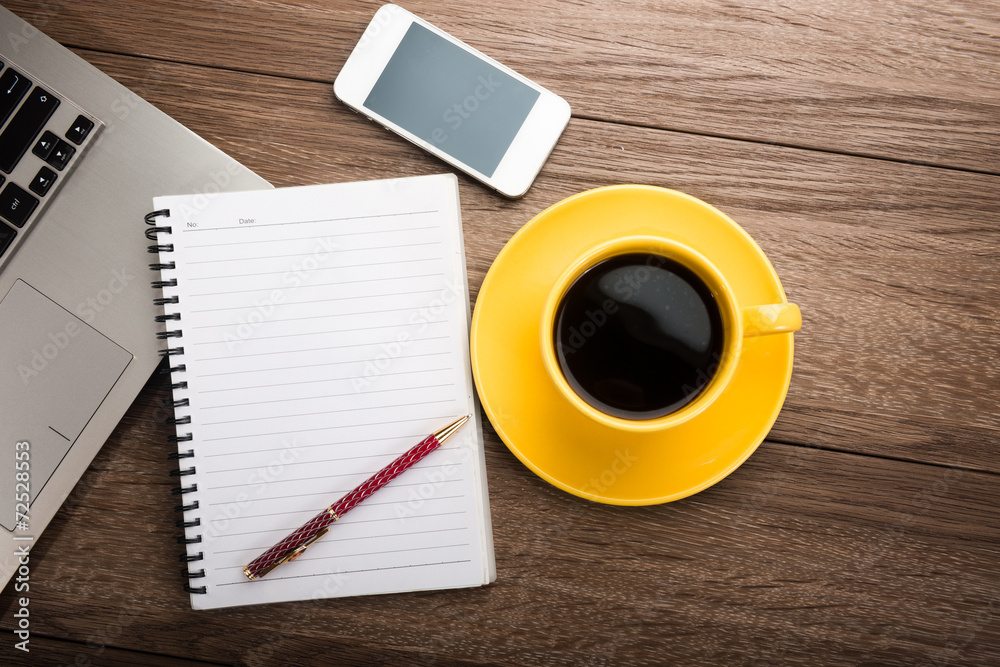 Office desk with devices? notebook and coffee cup. Office desk with devices? notebook and coffee cup.