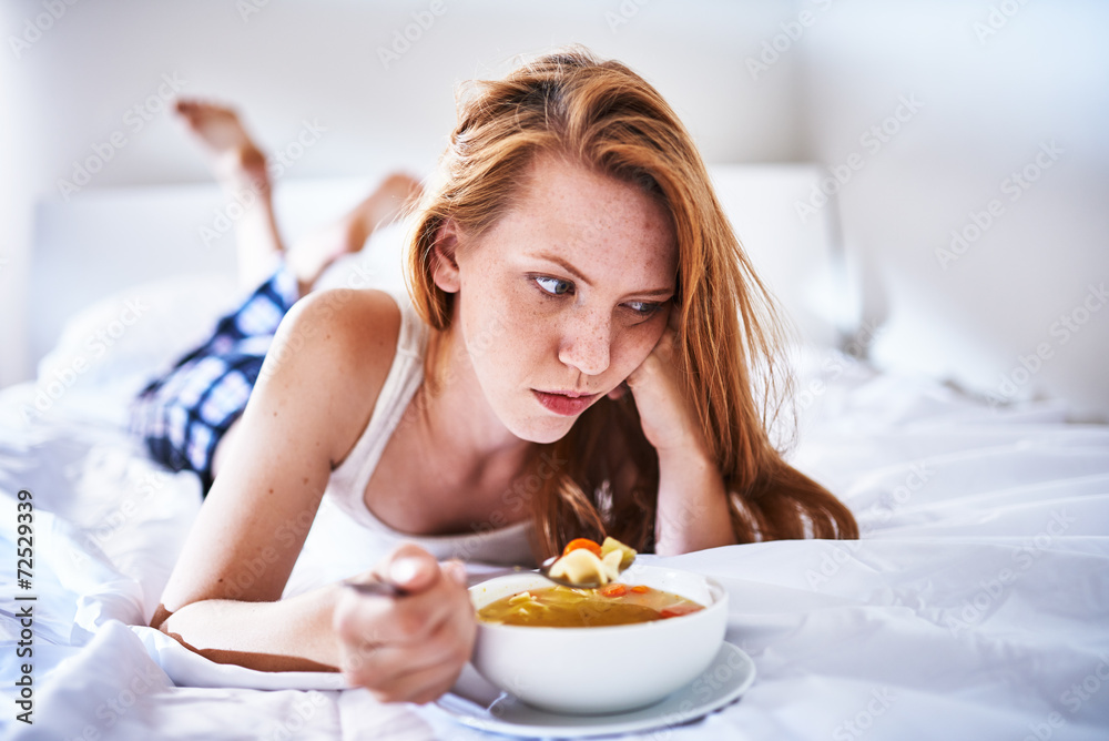 miserable woman with flu in bed with soup miserable woman with flu in bed with soup