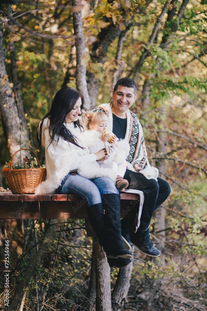 Happy family in an autumn forest near lake Happy family in an autumn forest near lake