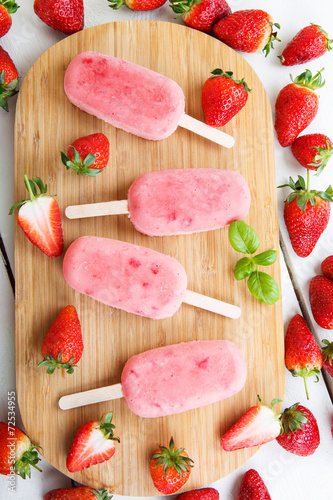 Homemade ice cream pops with fresh berries.