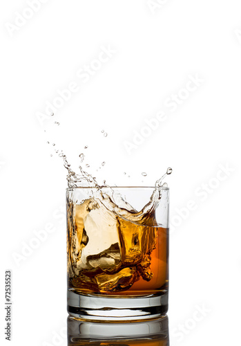 Isolated shots of whiskey with splash on white