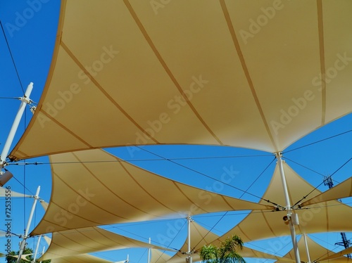 A roof of sunscreens shaped like sails in the desert of Austr