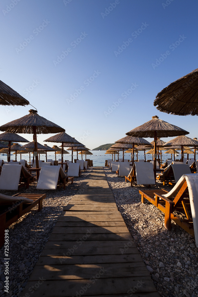   the photographed wooden umbrellas located in the territory of a beach