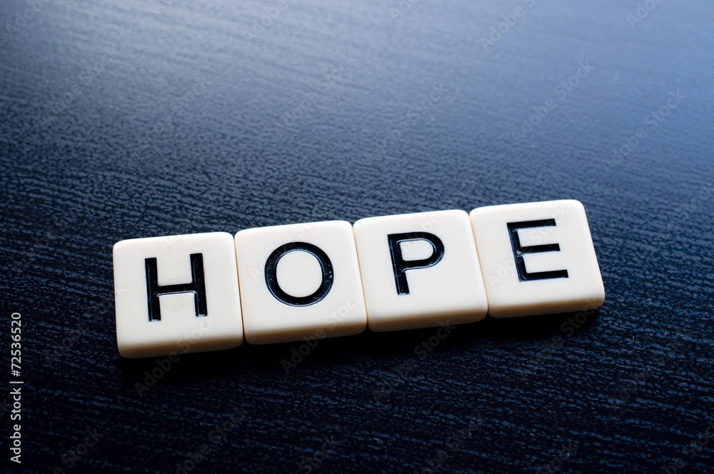 Obraz premium Hope on dark wood background