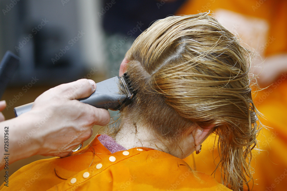 Fototapeta premium Blonde Haircut at the Salon with Hair Trimmer