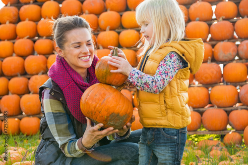 Mother and child choosing pumpkins