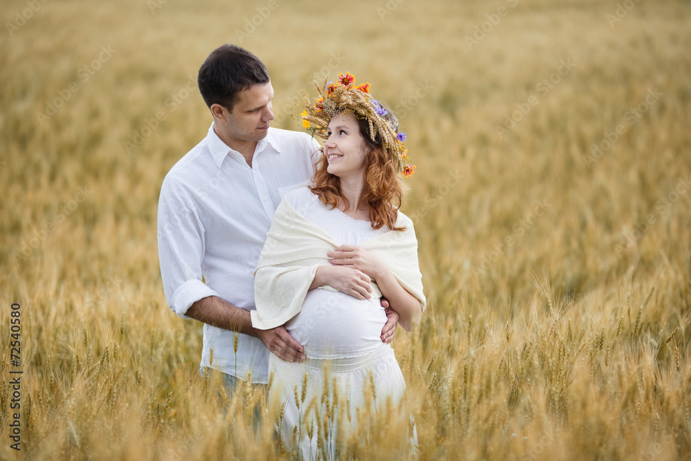 Outdoor portrait of young pregnant couple in field Outdoor portrait of young pregnant couple in field