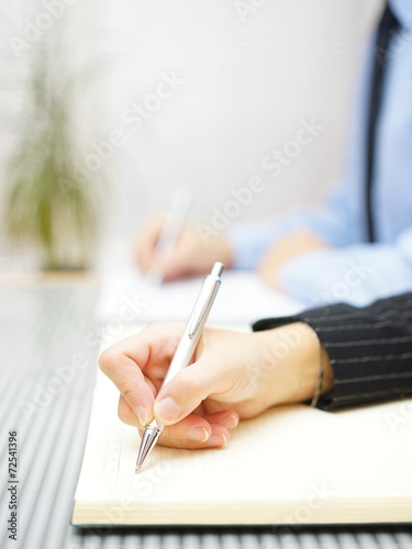 Business people writing notes  sitting in the office