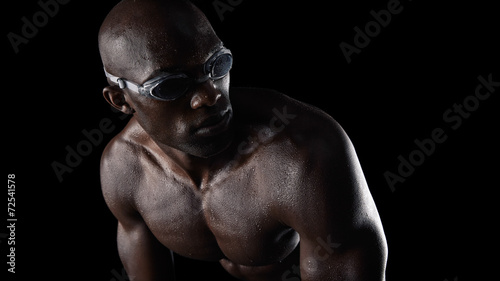 Swimmer wearing goggles looking over shoulder