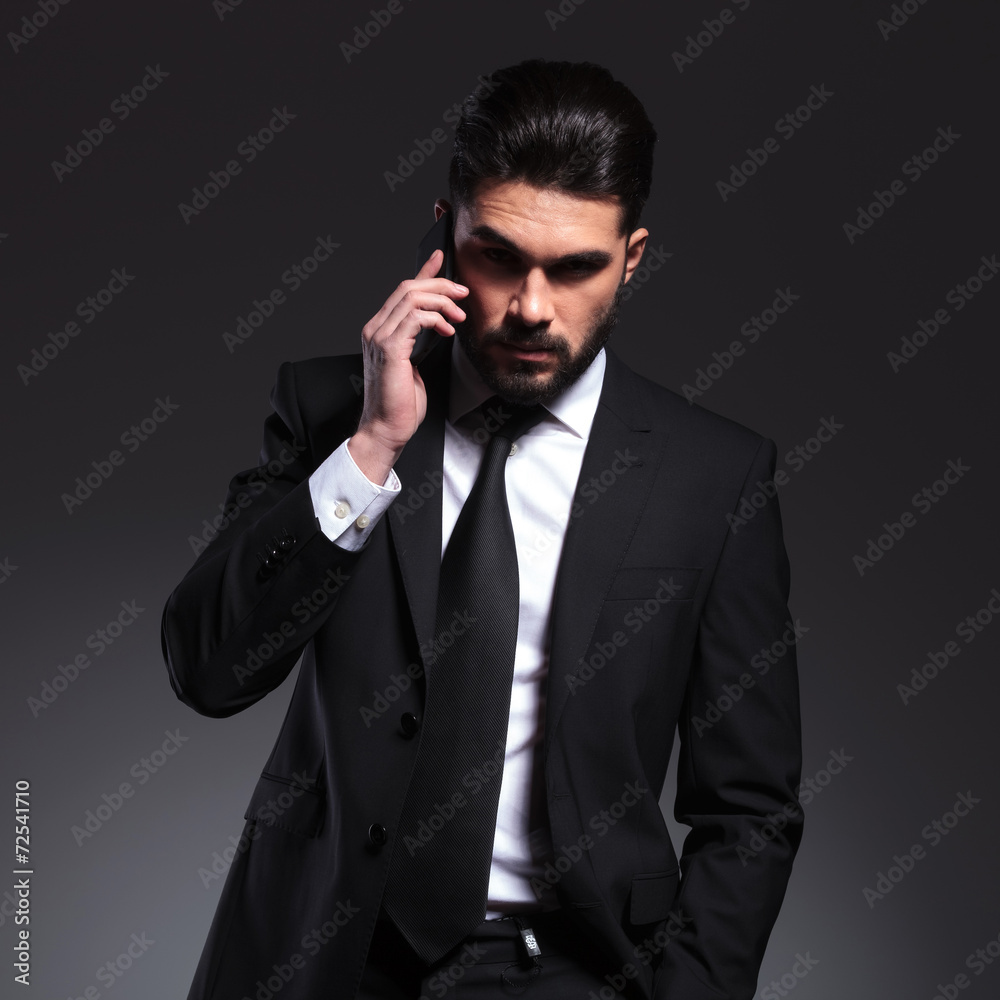 Front view of a young business man talking on the phone Front view of a young business man talking on the phone