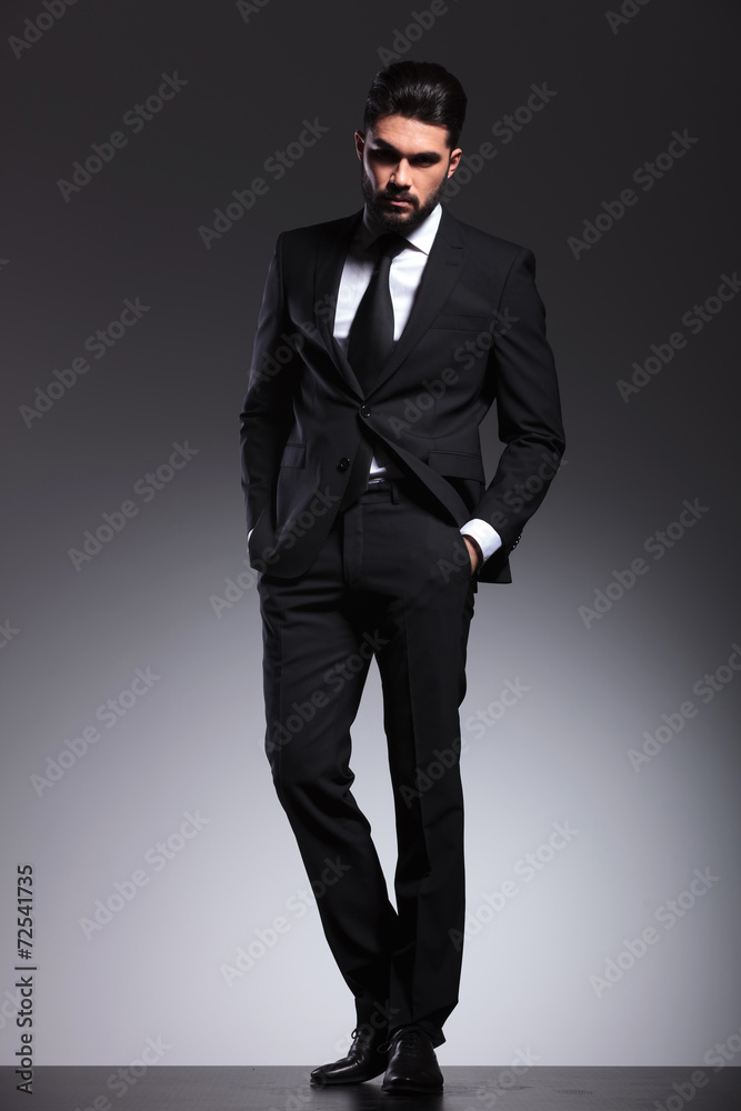 Young elegant business man holding his hands in pockets Young elegant business man holding his hands in pockets