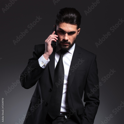 Front view of a young business man talking on the phone