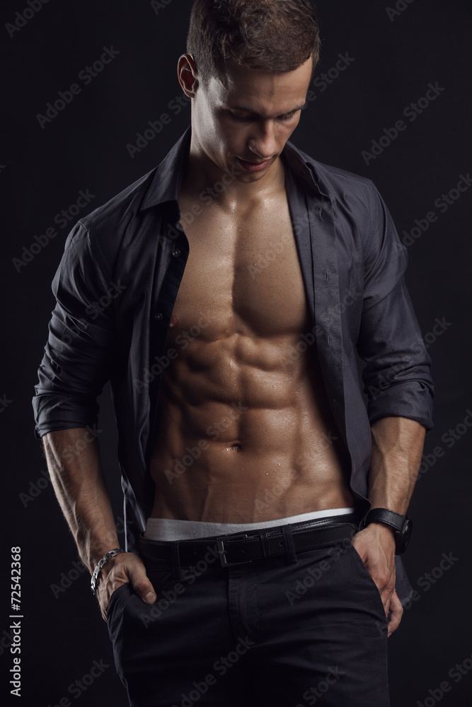 Naklejka premium Strong Athletic Man Fitness Model Torso showing six pack abs.