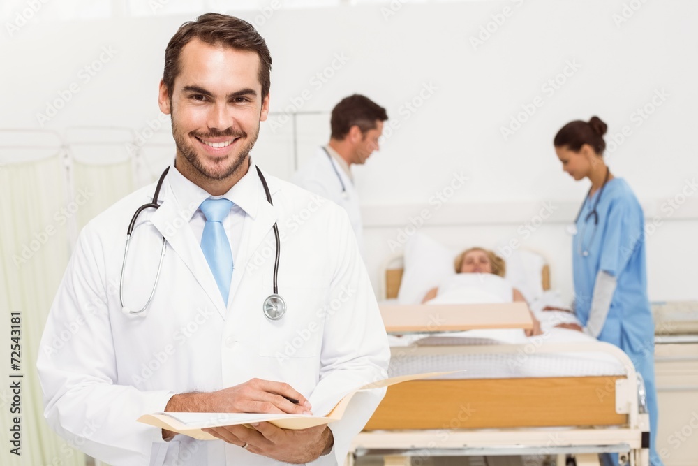 Fototapeta premium Doctor with colleagues and patient behind