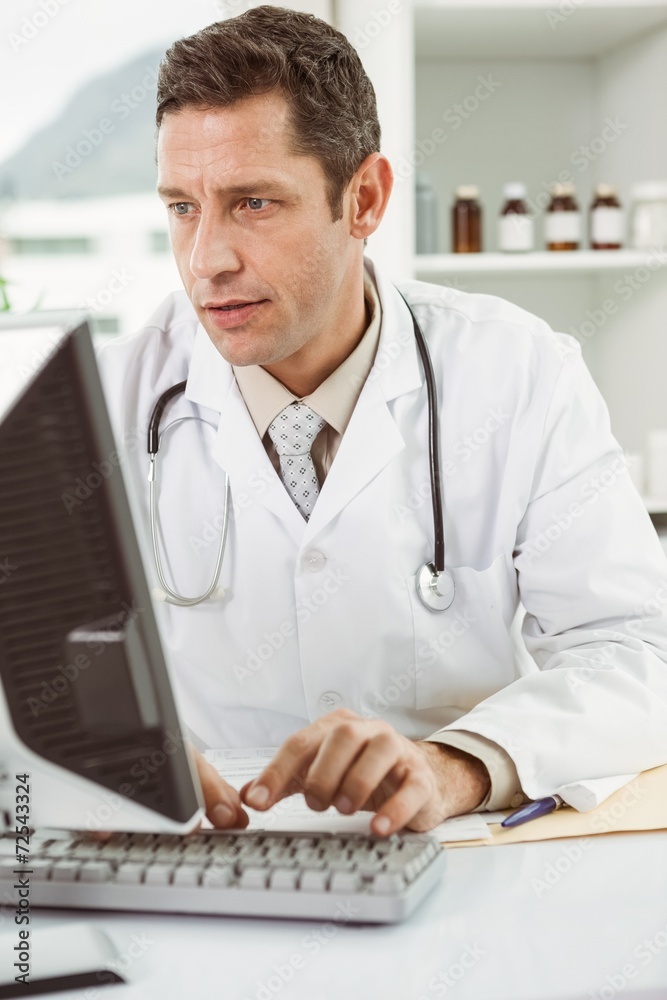 Doctor using computer at medical office Doctor using computer at medical office