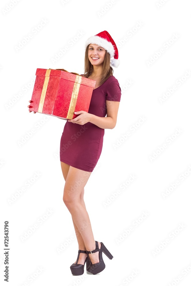 Festive brunette holding christmas gift Festive brunette holding christmas gift