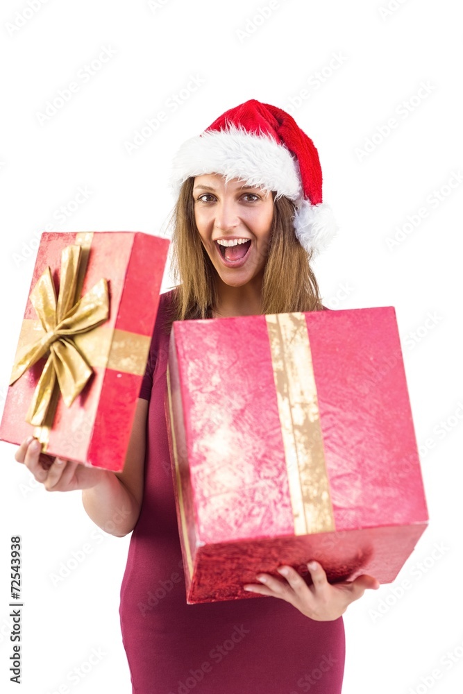 Surprised pretty brunette in santa hat opening gift Surprised pretty brunette in santa hat opening gift