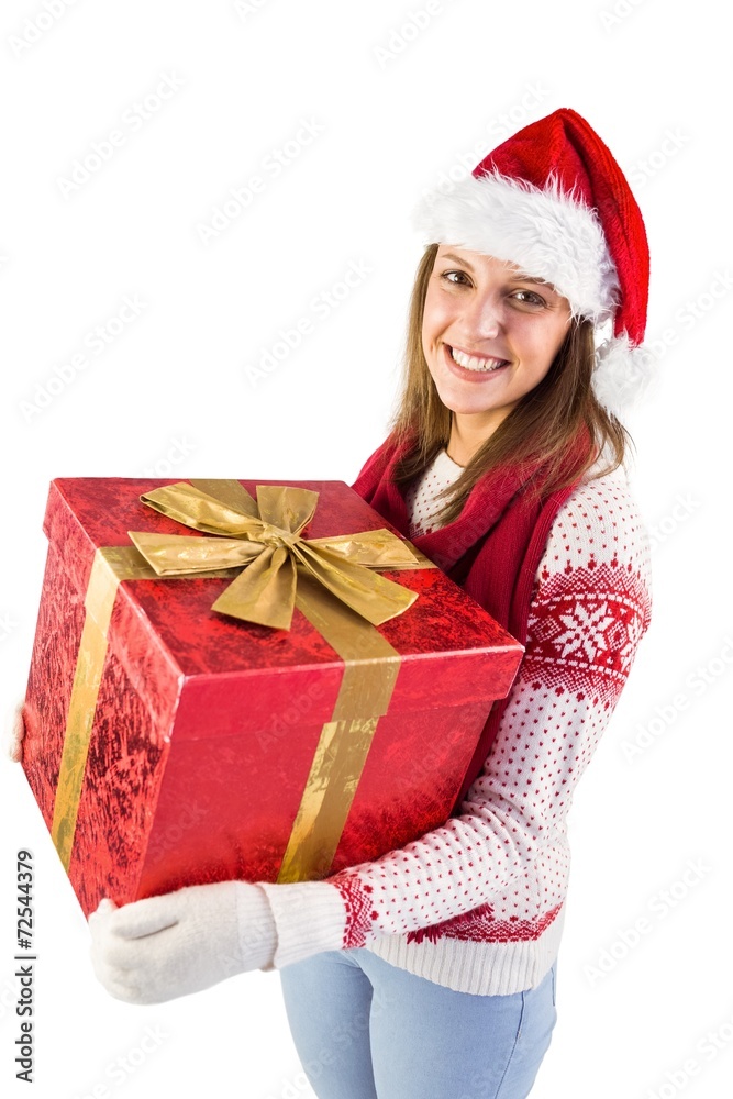 Young woman holding a gift while smiling at camera Young woman holding a gift while smiling at camera