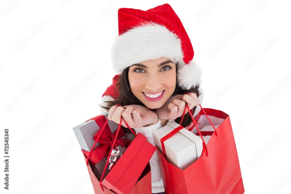 Smiling brunette holding shopping bags full of gifts Smiling brunette holding shopping bags full of gifts