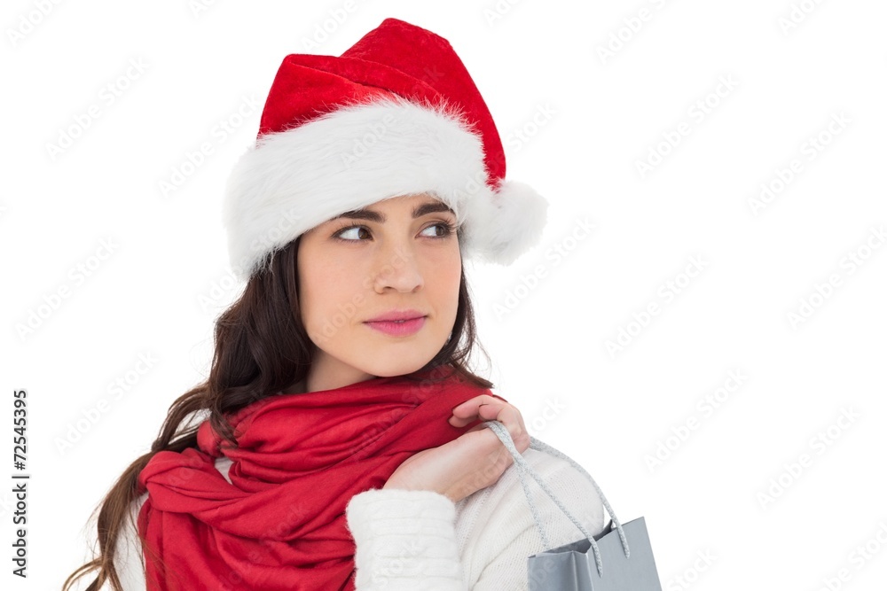 Brunette in santa hat holding shopping bag Brunette in santa hat holding shopping bag