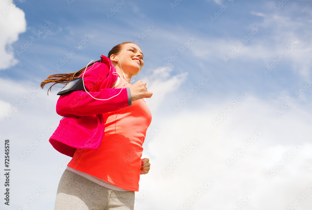 smiling young woman running outdoors smiling young woman running outdoors