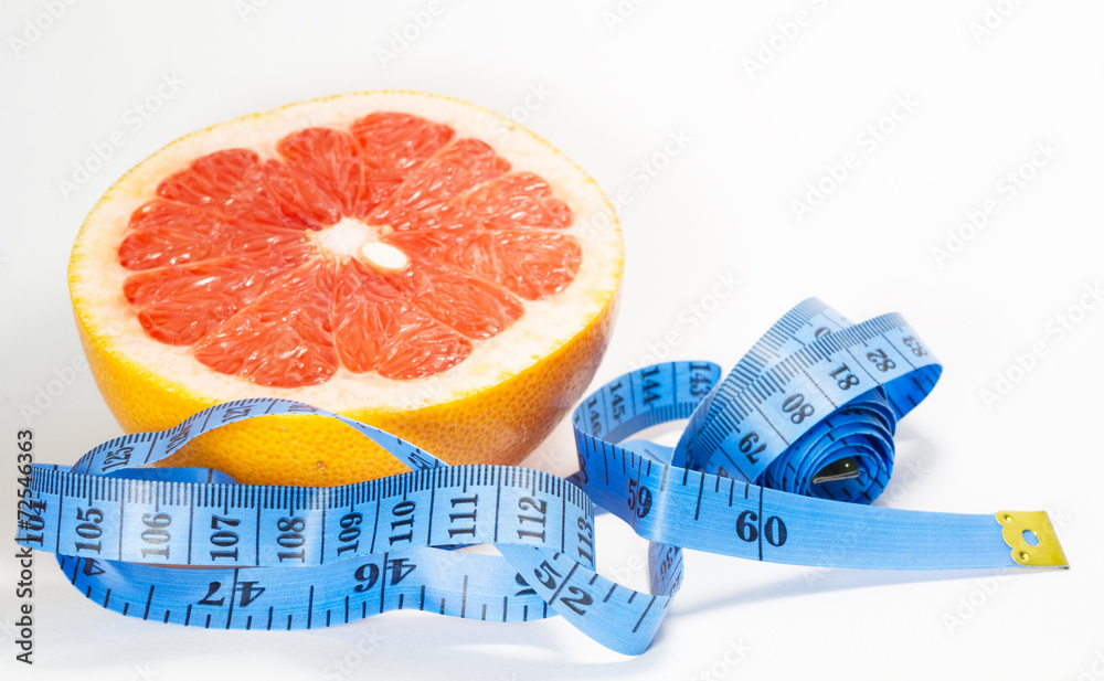 Meter and grapefruit isolated on white background
