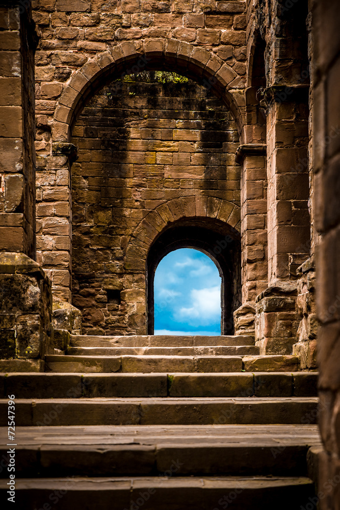 Stone castle steps and arched doors leading to blue sky - obrazy, fototapety, plakaty 