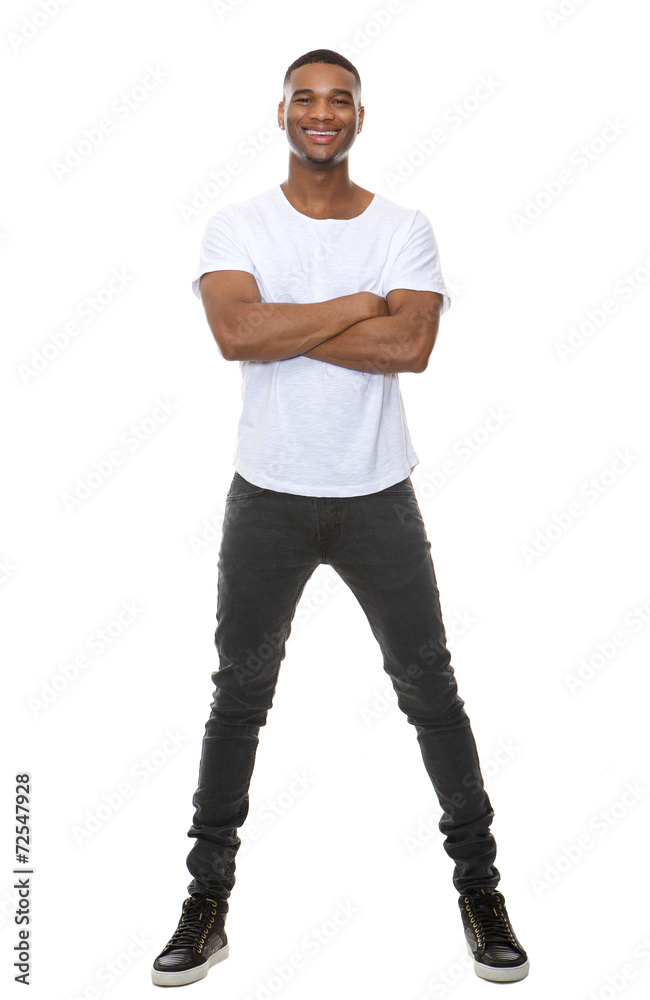Full length cool young guy smiling with arms crossed Full length cool young guy smiling with arms crossed