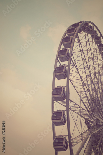 Ferris Wheel Silhouette vintage tone background © Nueng
