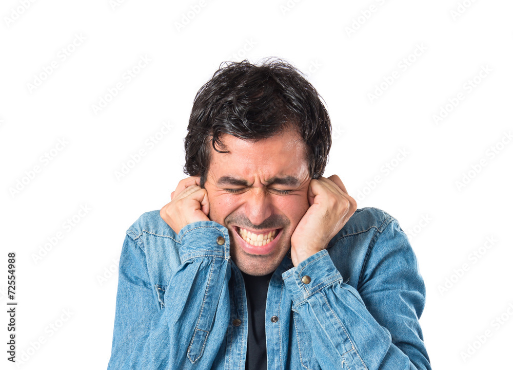 Man covering his ears over white background Man covering his ears over white background