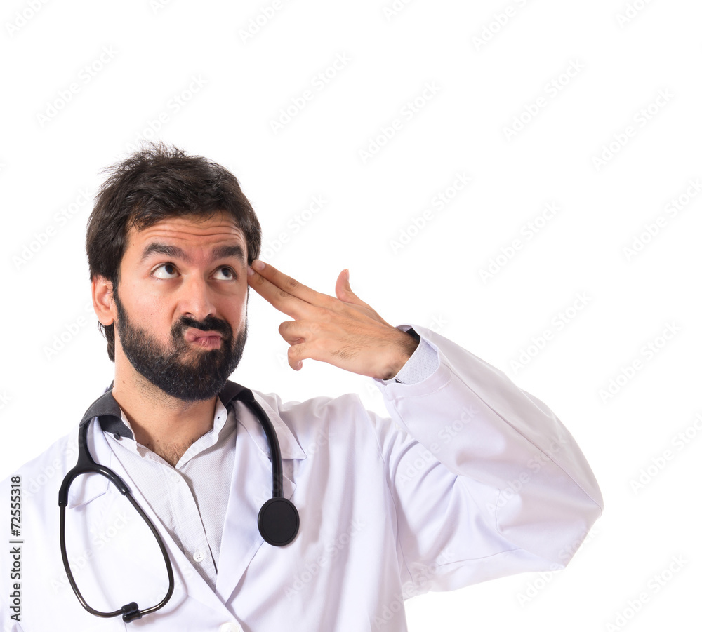 Doctor making suicide gesture over white background Doctor making suicide gesture over white background