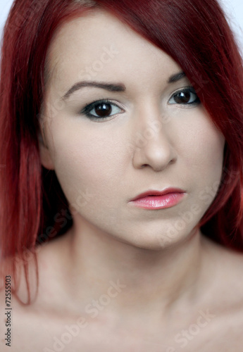 Beautiful redhead young woman with bright make up portrait