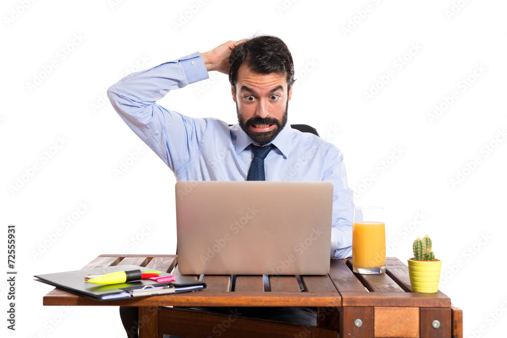 Businessman in his office having doubts Businessman in his office having doubts