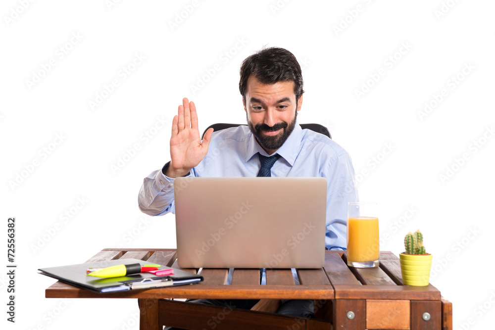 Businessman in his office saluting somebody