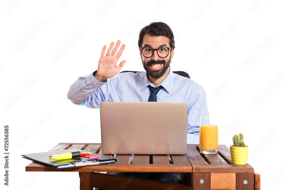 Businessman in his office saluting somebody Businessman in his office saluting somebody