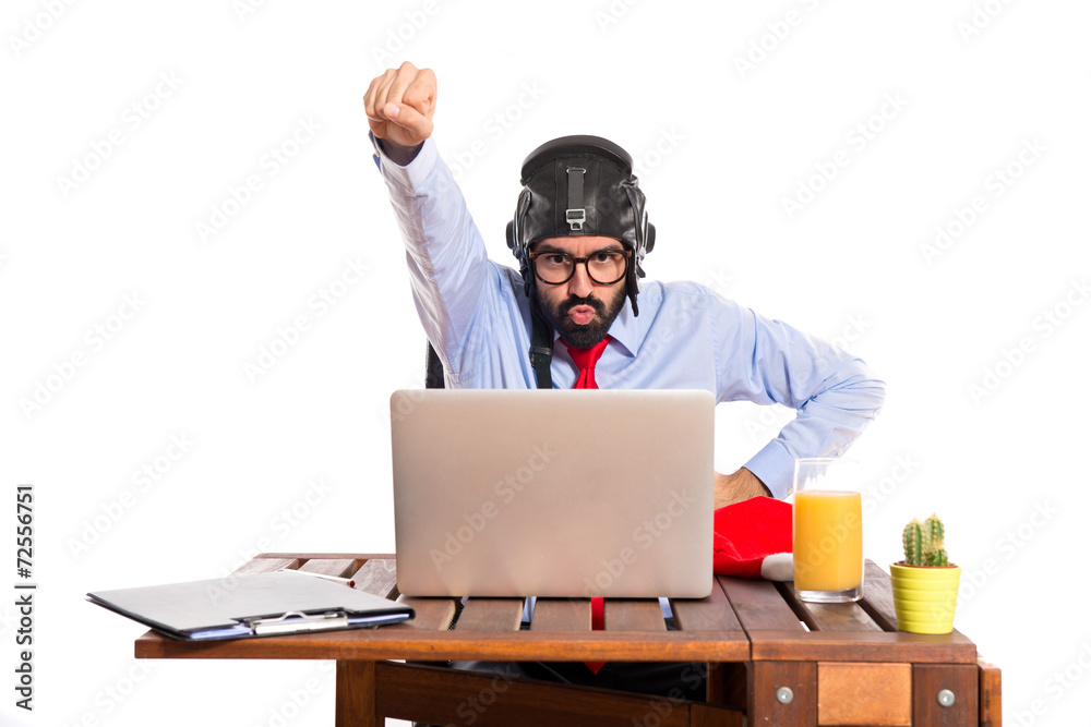 Businessman in his office with pilot hat Businessman in his office with pilot hat