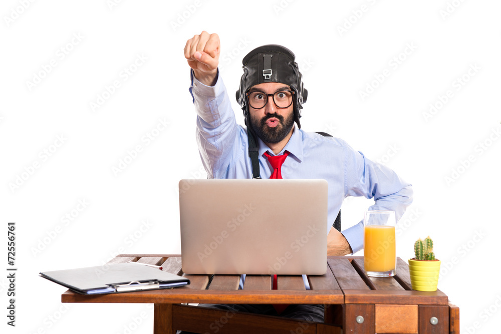 Businessman in his office with pilot hat Businessman in his office with pilot hat