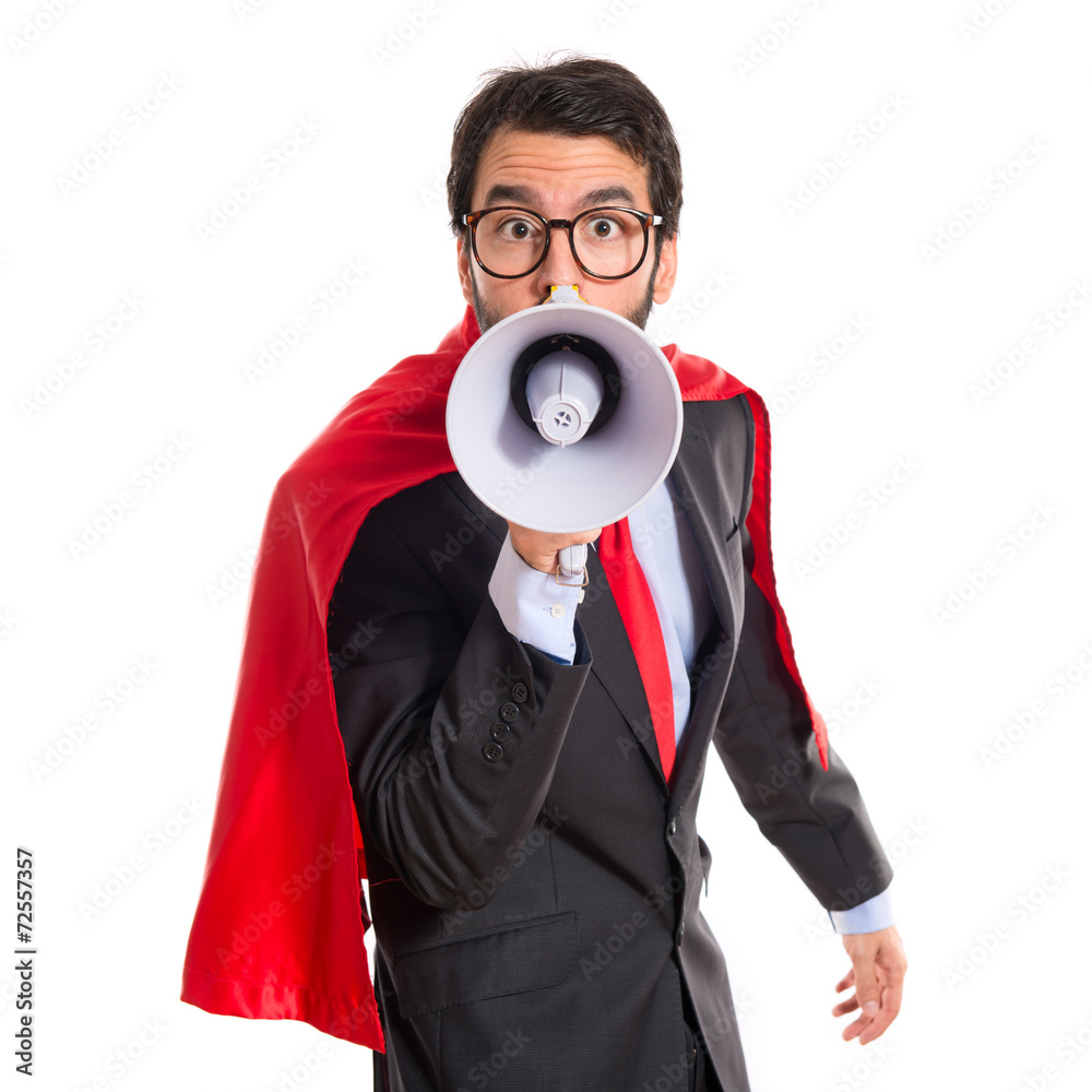 Businessman dressed like superhero shouting by megaphone Businessman dressed like superhero shouting by megaphone